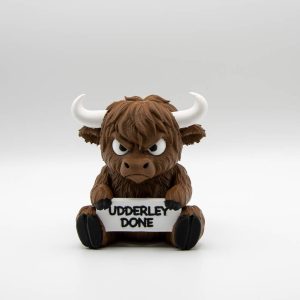 Grumpy 3D printed Highland cow holding an Udderly Done sign, front view