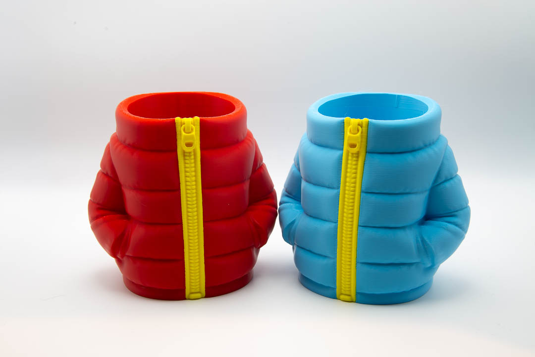 Red and light blue puffer jacket can holders side by side
