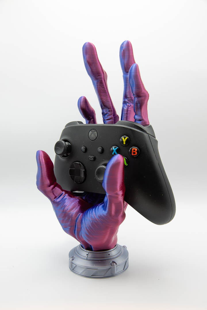 Alien hand controller holder holding an Xbox controller, angled view