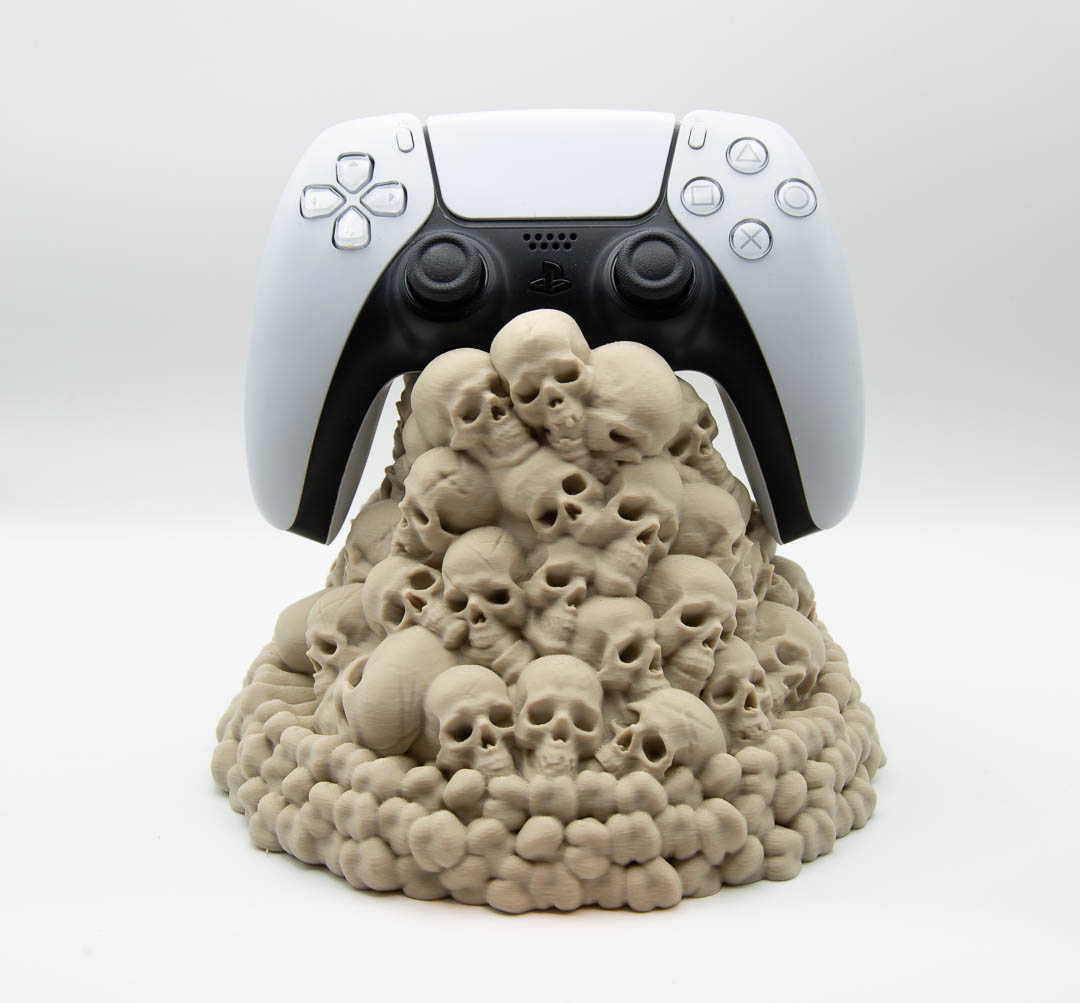 Skull pile controller holder holding a PS5 controller