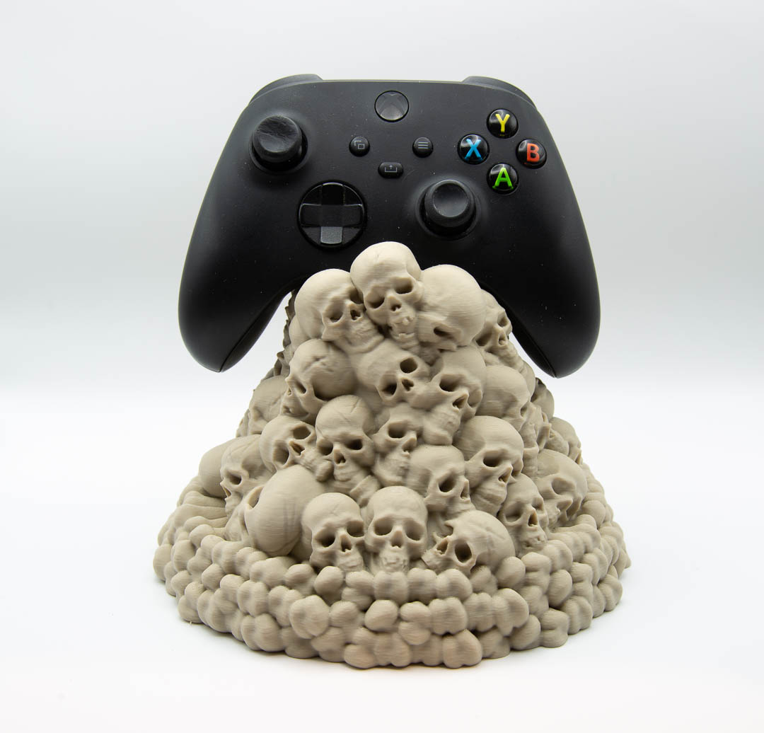 Skull pile controller holder holding an Xbox controller