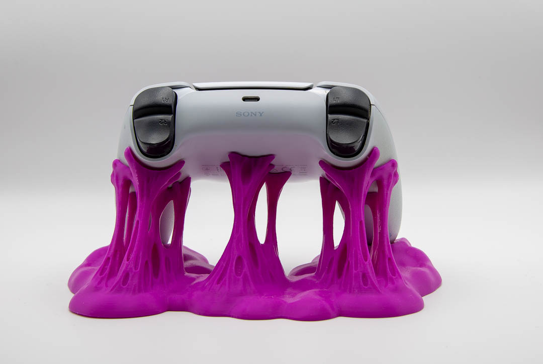 Magenta sticky slime controller holder with a PS5 DualSense controller