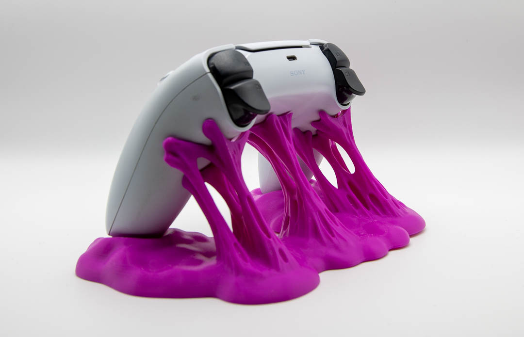 Magenta sticky slime controller holder with a PS5 DualSense controller