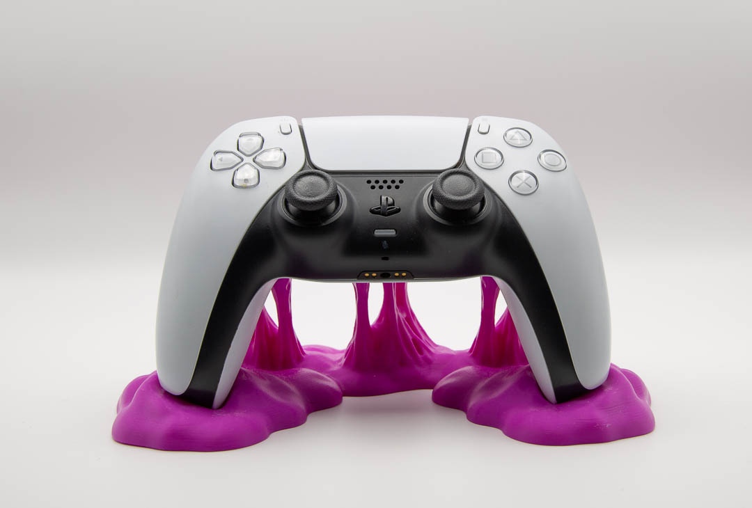 Magenta sticky slime controller holder with a PS5 DualSense controller