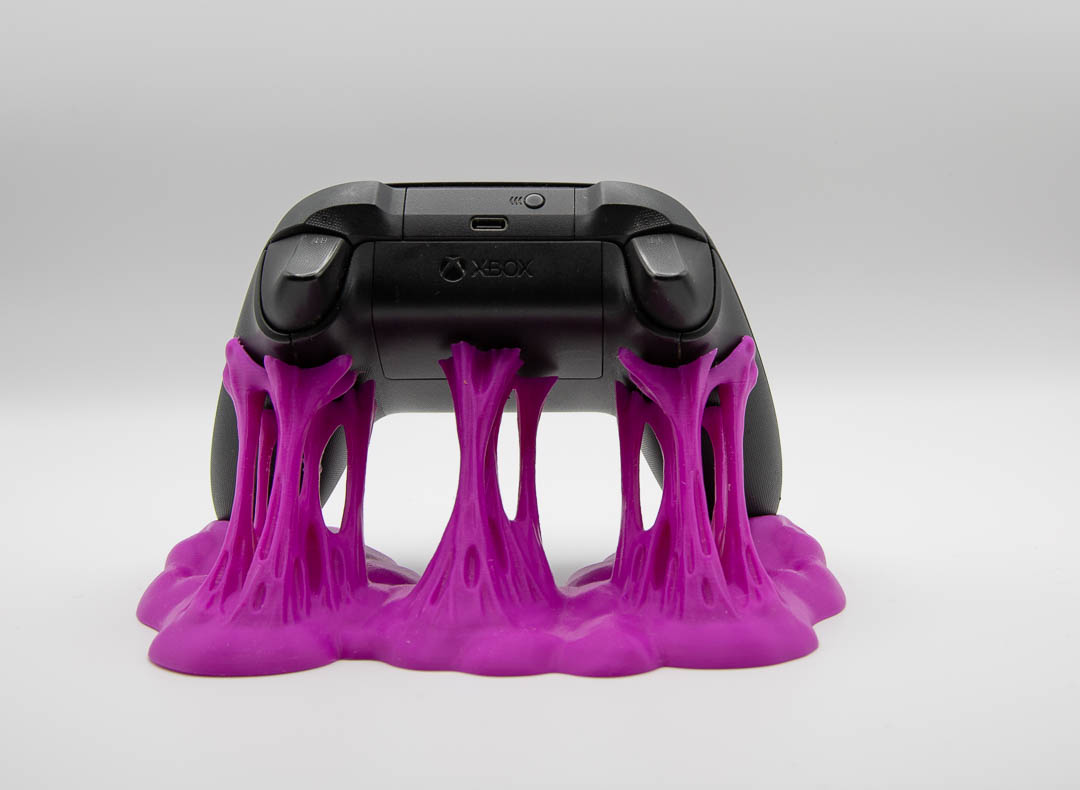 Magenta sticky slime controller holder with an Xbox controller