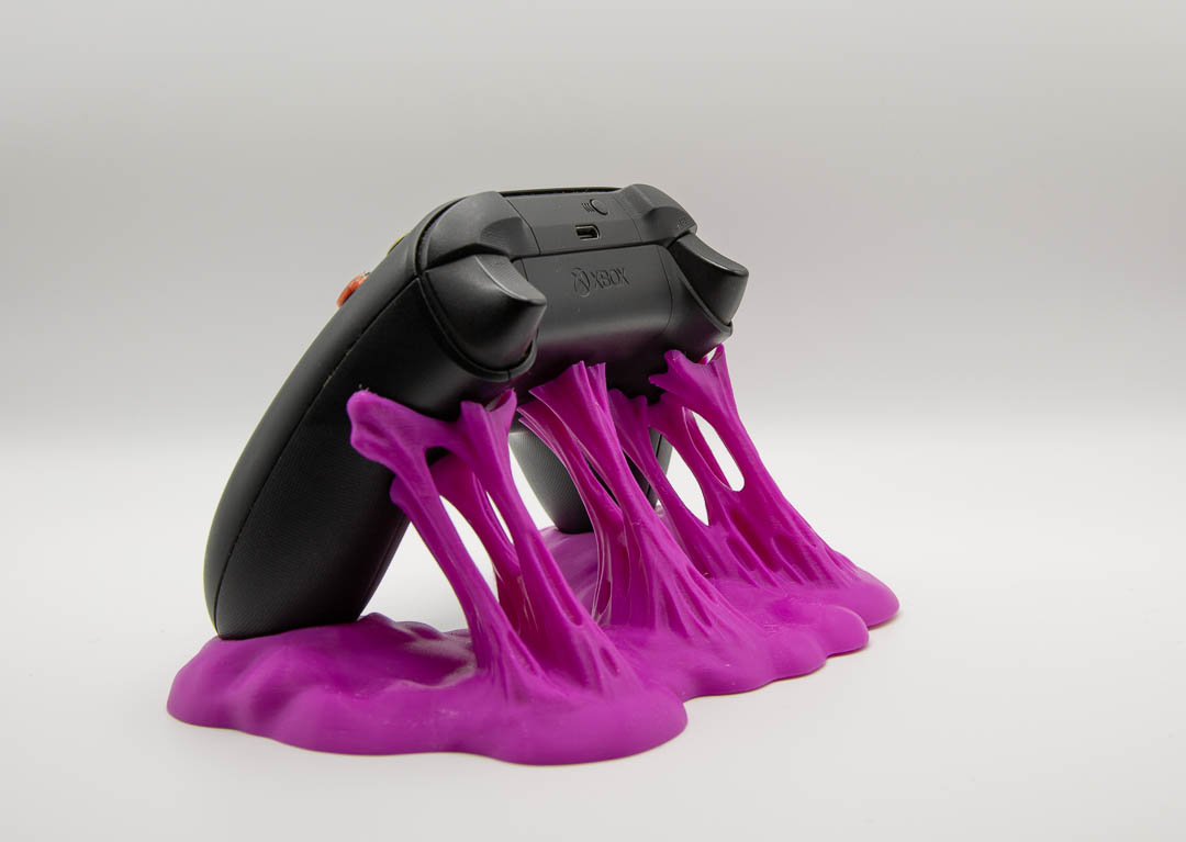 Magenta sticky slime controller holder with an Xbox controller