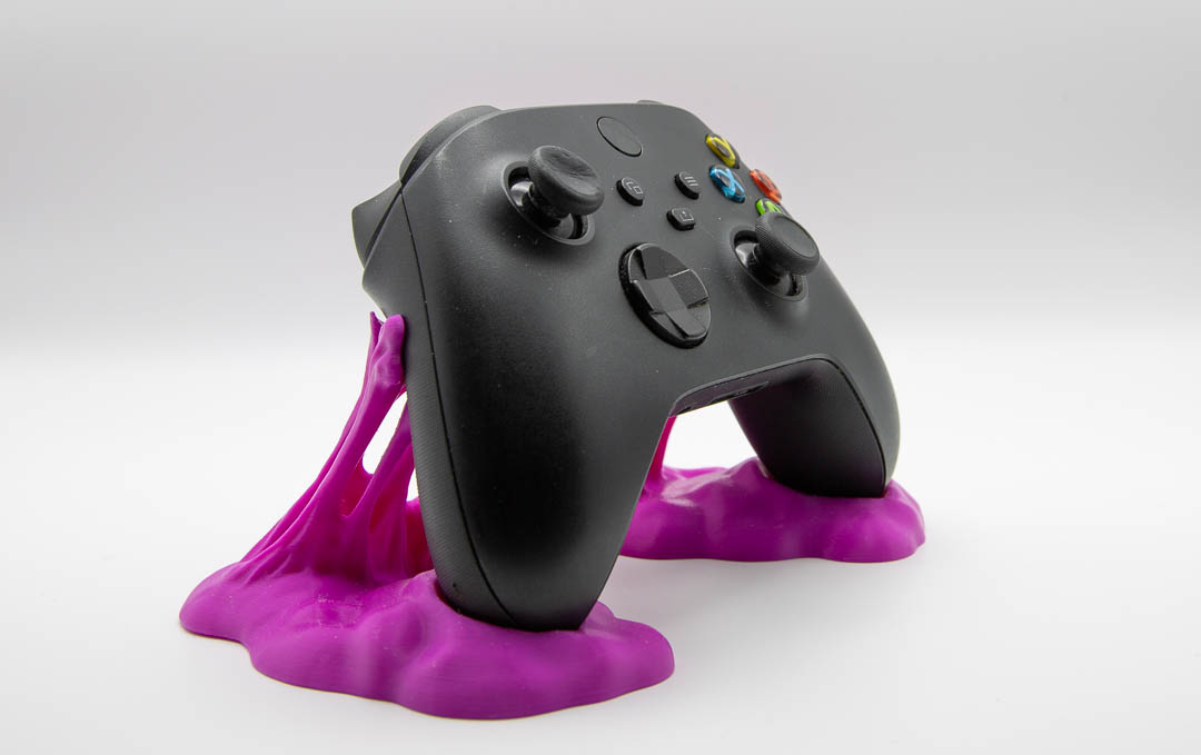 Magenta sticky slime controller holder with an Xbox controller